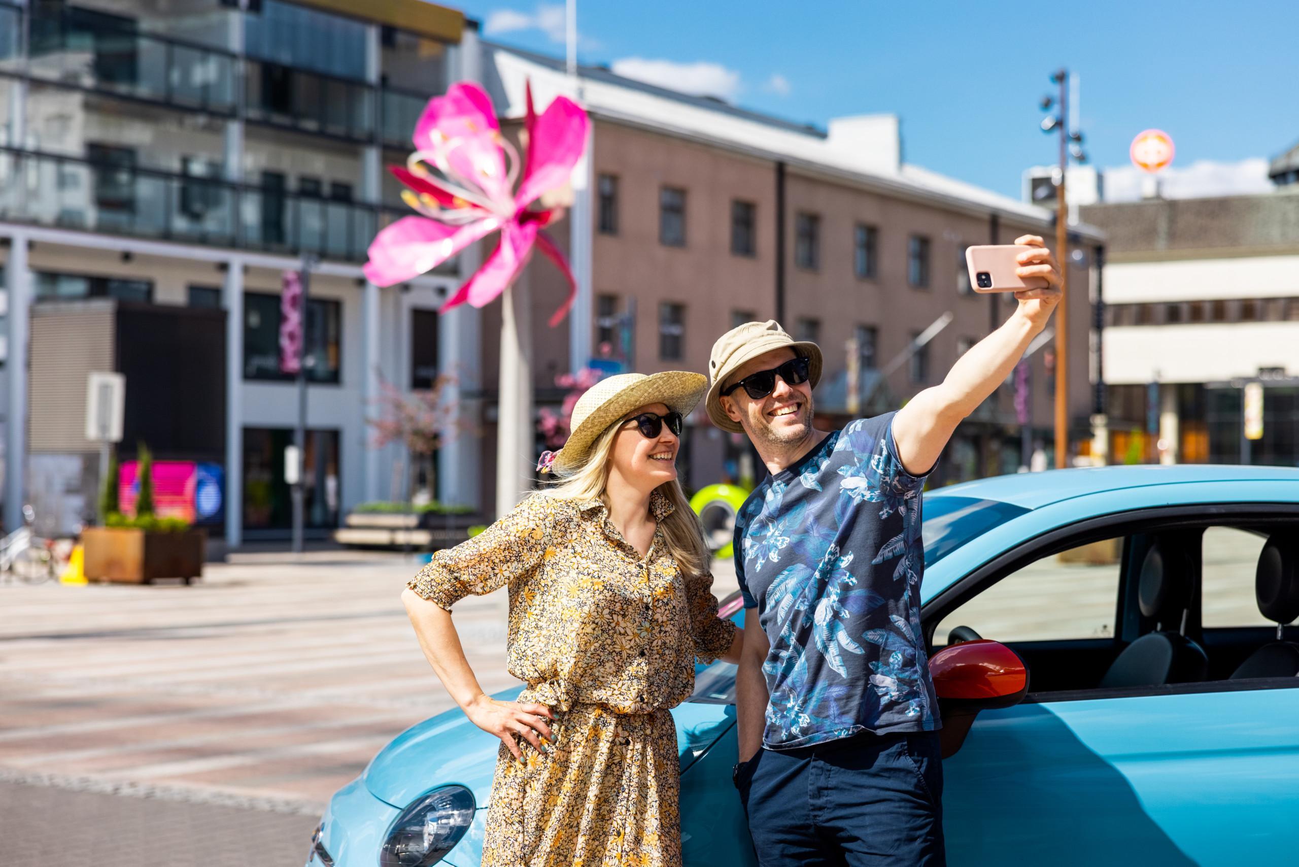 Matkailijat ottavat selfietä Seinäjoen torilla Horsma patsaan edessä.